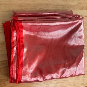 Shiny red fabric. Very slippery.  5 feet x 12 feet.